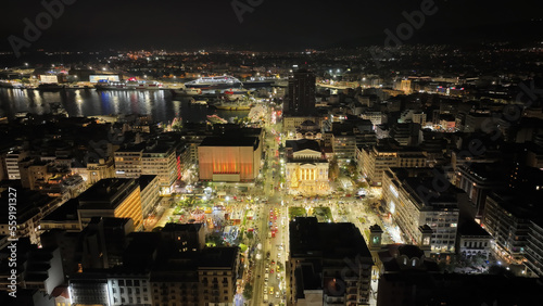 Aerial drone night shot of famous neoclassic Municipal Theatre of Piraeus and recently renovated main square illuminated during Christmas period, Attica, Greece © aerial-drone