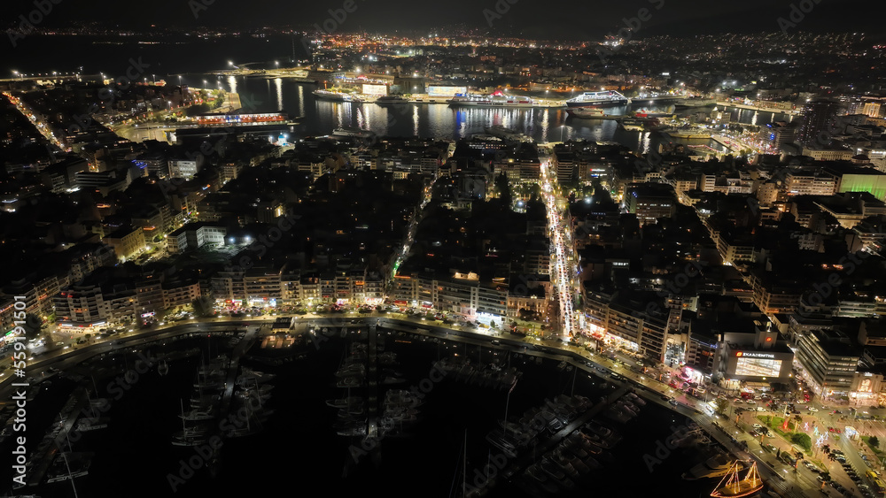 Aerial drone night shot of famous illuminated round port and marina of Zea or Pasalimani in the heart of Peiraeus, Attica, Greece