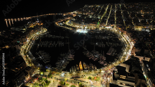 Aerial drone night shot of famous illuminated round port and marina of Zea or Pasalimani in the heart of Peiraeus, Attica, Greece © aerial-drone