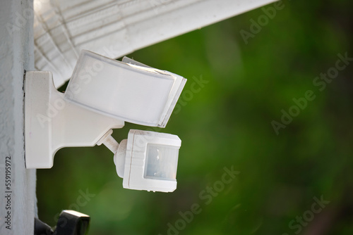 Canvas Print Motion sensor with light detector mounted on exterior wall of private house as p