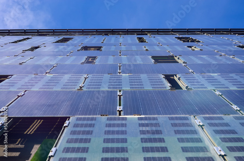 The walls of the building are tiled with solar panels.	