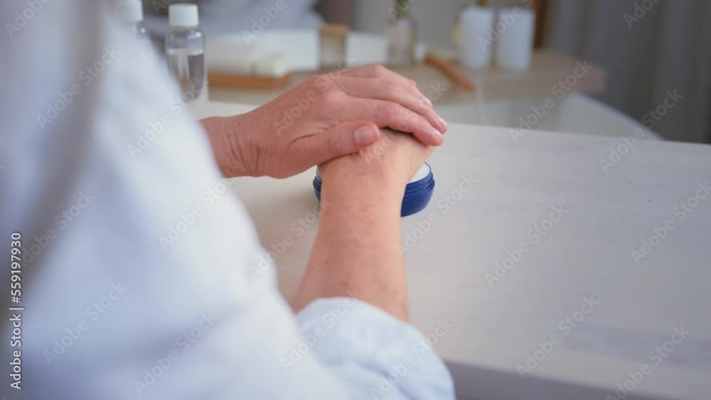 Female beauty procedures health skincare concept. Close up unrecognizable old senior mature middle-aged wrinkled woman rubbing hands applying natural hand cream skin sensual moisturizing rejuvenation Female beauty procedures health skincare concept. Close up unrecognizable old senior mature middle-aged wrinkled woman rubbing hands applying natural hand cream skin sensual moisturizing rejuvenation