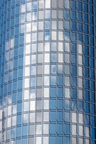 modern round glass buildings with cloudy blue sky background.