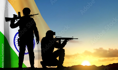 Silhouette of soldiers with India flag on a background the sunset. EPS10 vector