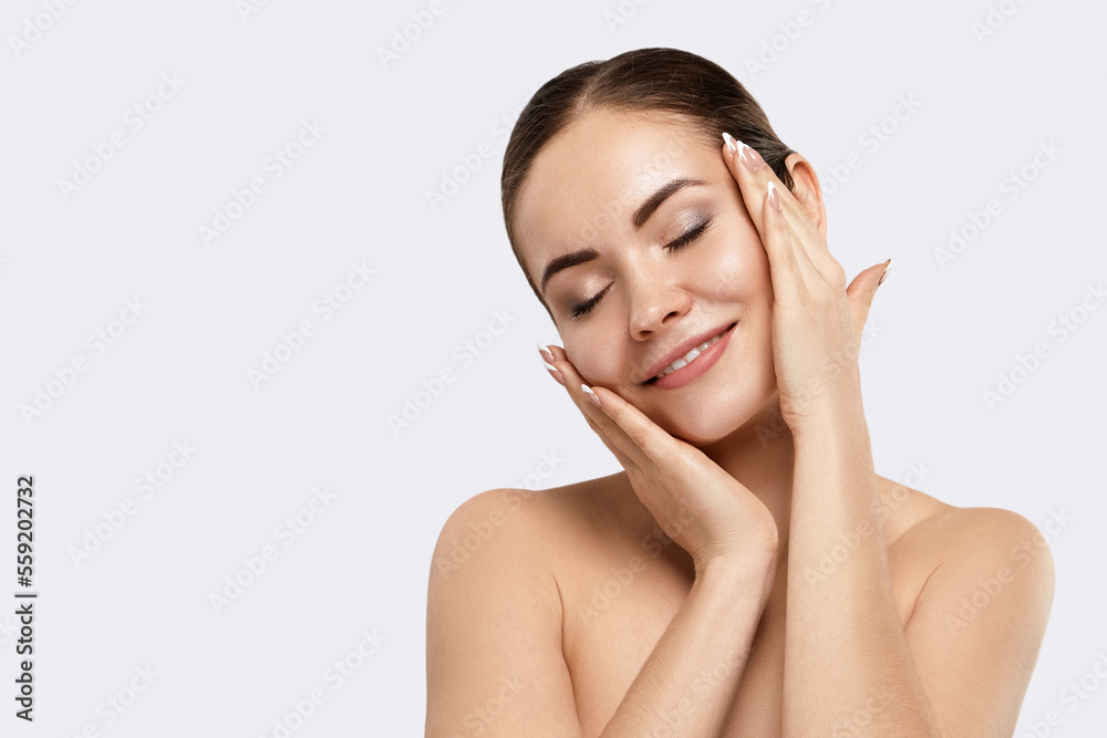 Beautiful Young Woman with Clean Fresh Skin touch own face. Facial  treatment. Skin care. Cosmetology, beauty  and spa.