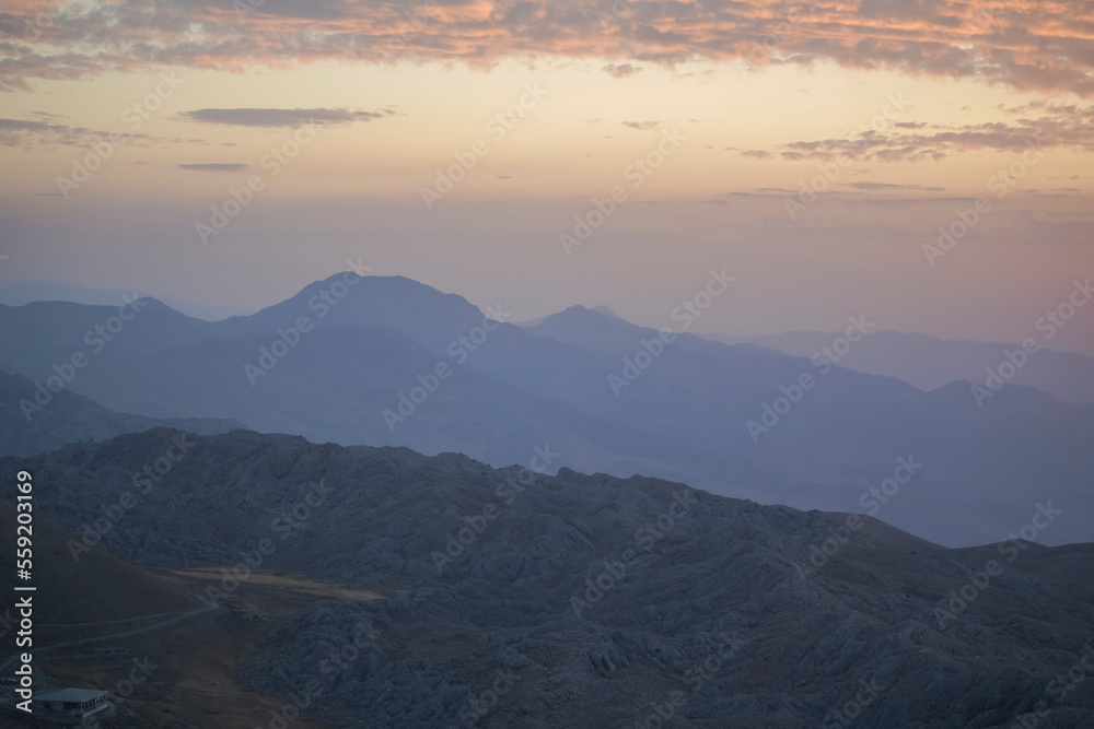 Sunrise view of mount nemrut, the sun cames up from east behind the mountains and lake and colorful clouds make the view better Sunrise view of mount nemrut, the sun cames up from east behind the mountains and lake and colorful clouds make the view better