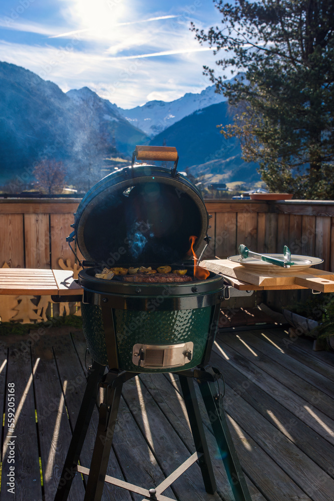 grilling at a sunny winter day - a grilled steak with potaoes, onions and rosemary from a outdoor charcoal grill grilling at a sunny winter day - a grilled steak with potaoes, onions and rosemary from a outdoor charcoal grill
