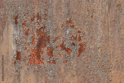 Texture of a metallic rusty wall.Cracked peeling old paint on a metallic rusty surface