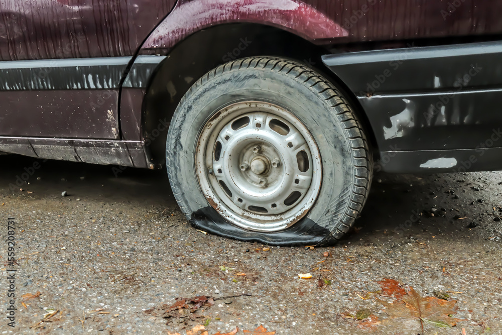 Flat tire of an old car close-up Flat tire of an old car close-up
