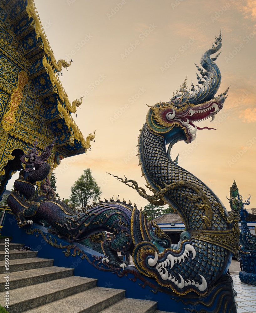 Fototapeta premium Wat Rong Seur Ten or Blue temple. Modern Buddhist temple distinguished by its vivid blue and yellow coloring elaborate carvings. Northern Thailand