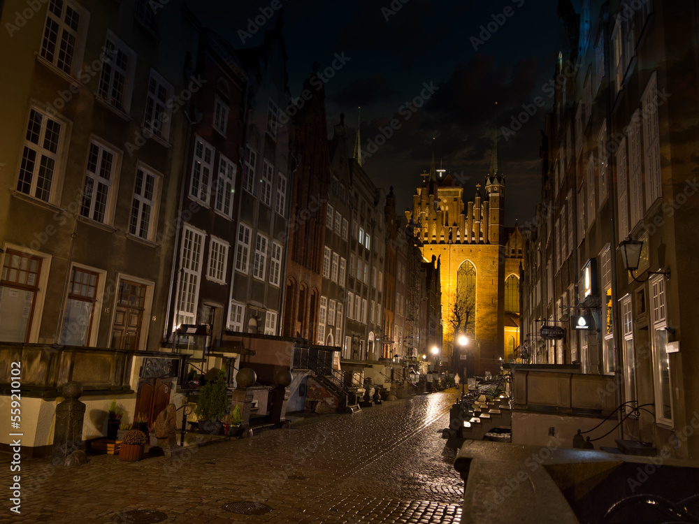View of the street in the center of the old town at night. Architecture of an old historic street in Gdansk. Old town tourist attraction. Gdansk, Poland.