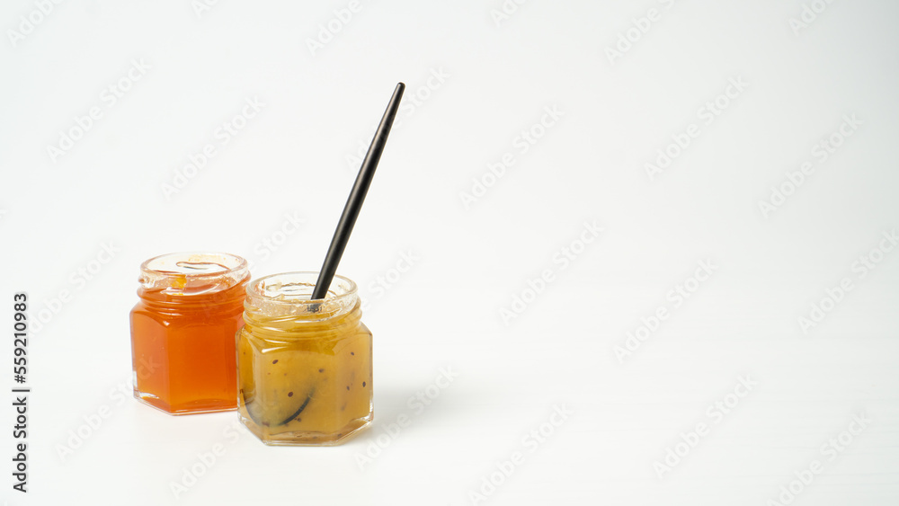 Tiny jam jars on white background. Mini jars of jam. Different fruit jams in glass bottles Tiny jam jars on white background. Mini jars of jam. Different fruit jams in glass bottles