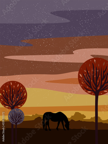 Silhouette of a free horse walking across the field against the backdrop of sunset and trees.