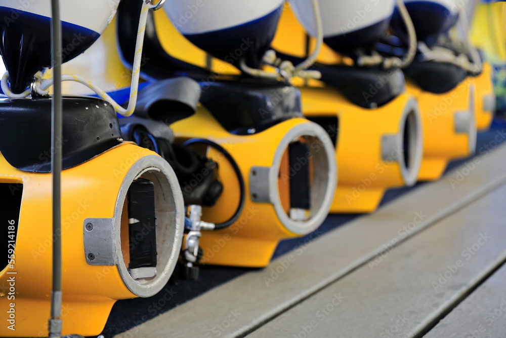 Row of yellow diving scooters on a tourist pontoon. Great Barrier Reef-Australia-388 Row of yellow diving scooters on a tourist pontoon. Great Barrier Reef-Australia-388