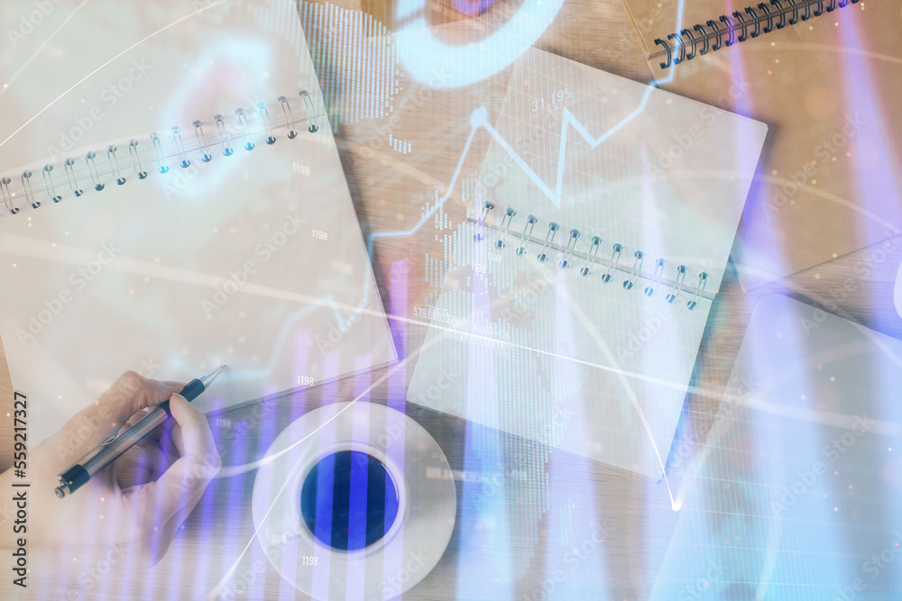 Multi exposure of woman's hands making notes with forex graph hologram. Concept of technical analysis. Multi exposure of woman's hands making notes with forex graph hologram. Concept of technical analysis.