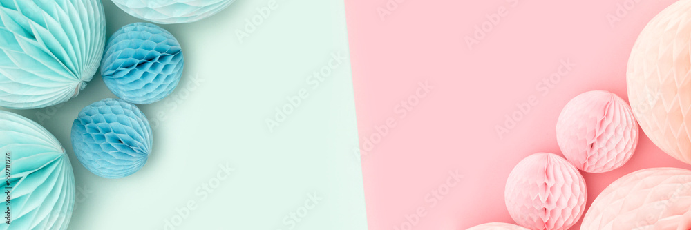 Banner with border frame made of tissue paper balls in a pink and blue colors. Gender reveal party concept with copy space. Banner with border frame made of tissue paper balls in a pink and blue colors. Gender reveal party concept with copy space.