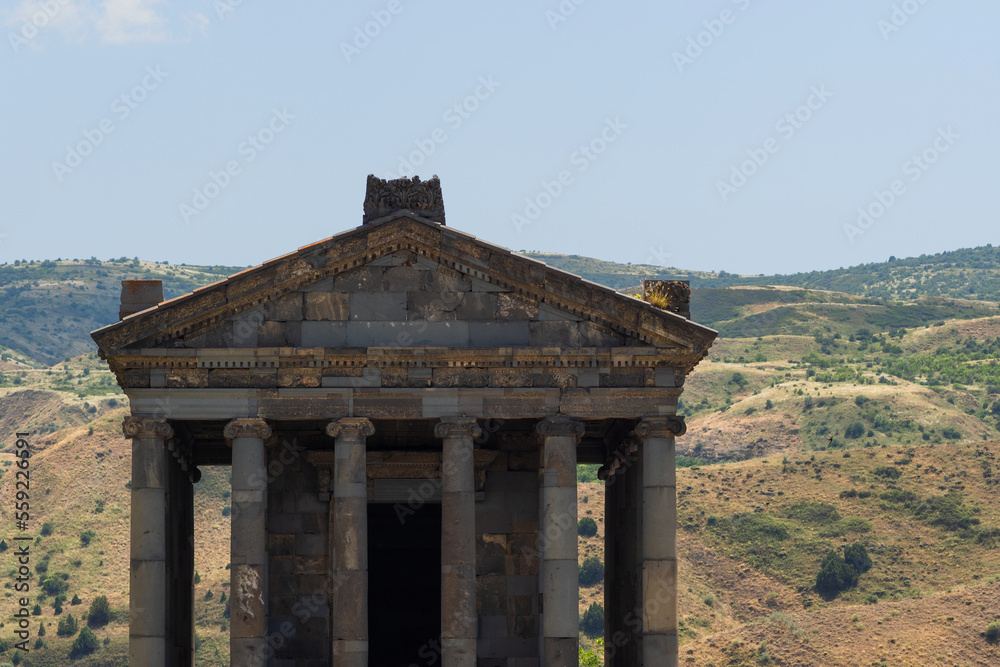 The temple in Garni , a pagan temple in Armenia, built in the I century AD. Facade with a classic colonnade on the background of mountains