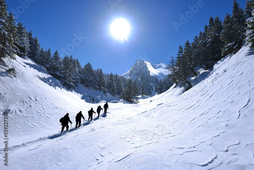 team of mountaineers hiking in the mountains with a magnificent winter view
