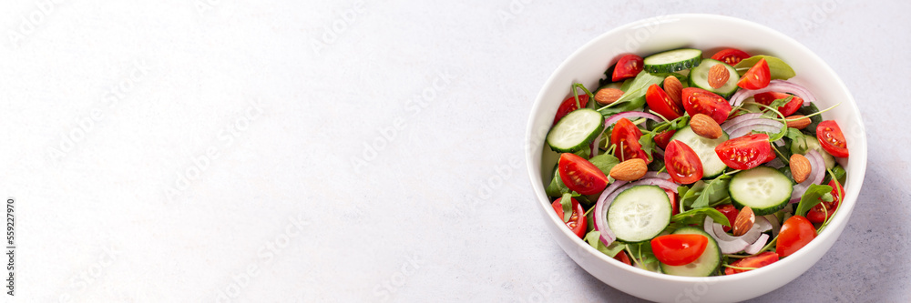 Healthy salad with spelt, oranges, pomegranate seeds. greens and nuts on light background, minimal style Healthy salad with spelt, oranges, pomegranate seeds. greens and nuts on light background, minimal style