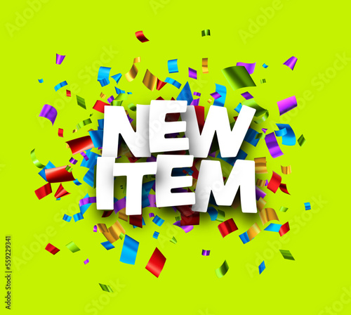 New item sign over colorful cut out foil ribbon confetti background.