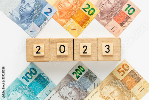 Brazilian money and the date 2023 on wooden blocks, Economic concept, Development of the Brazilian economy in 2023