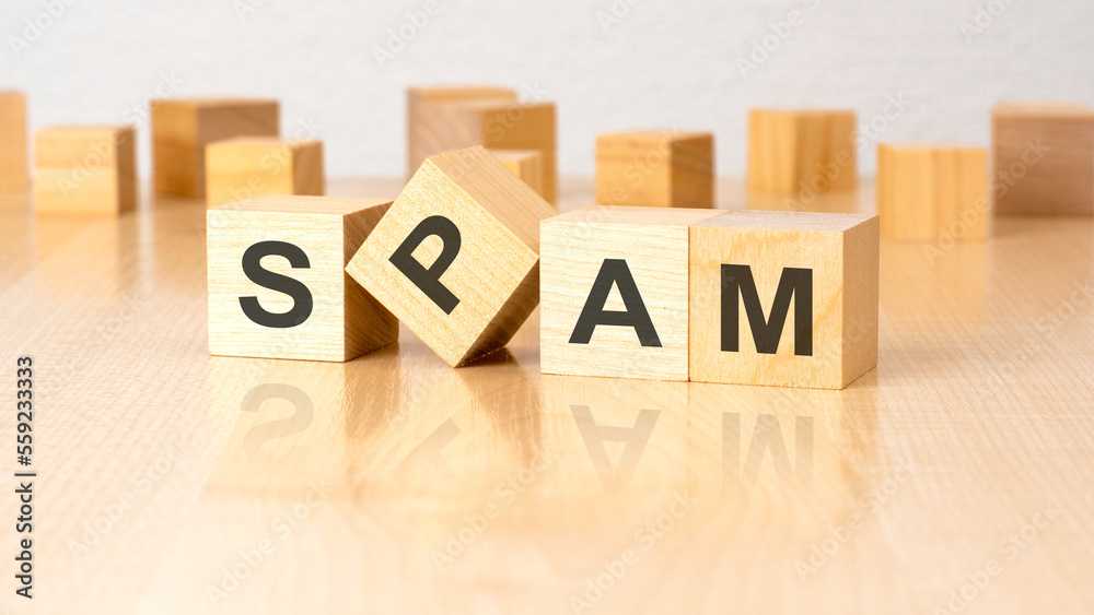 Obraz premium four wooden blocks with text SPAM on table. copy space. white background.