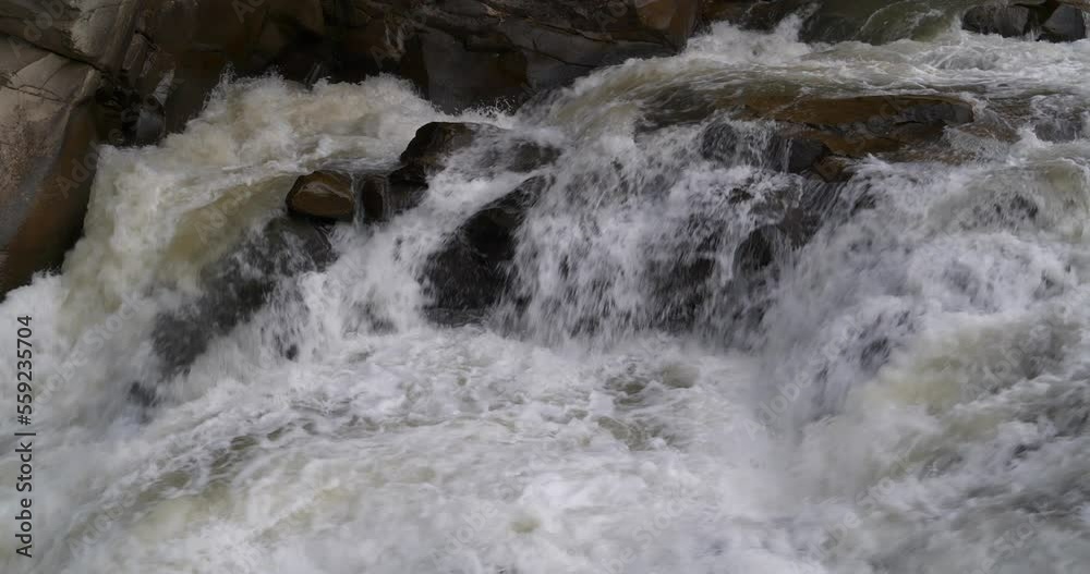 Slow Motion Beautiful powerful waterfall and rocks. Cinema 4K one minute video Slow Motion Beautiful powerful waterfall and rocks. Cinema 4K one minute video