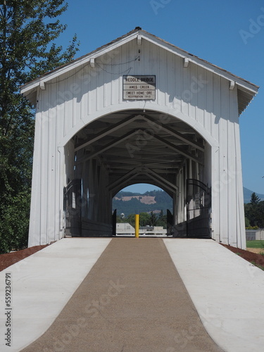 Walking Paths through the open-sided Weddle Covered Bridge that originally spanned Thomas Creek and has been relocated to cross Ames Creek Sankey Park in Sweet Home, Oregon.