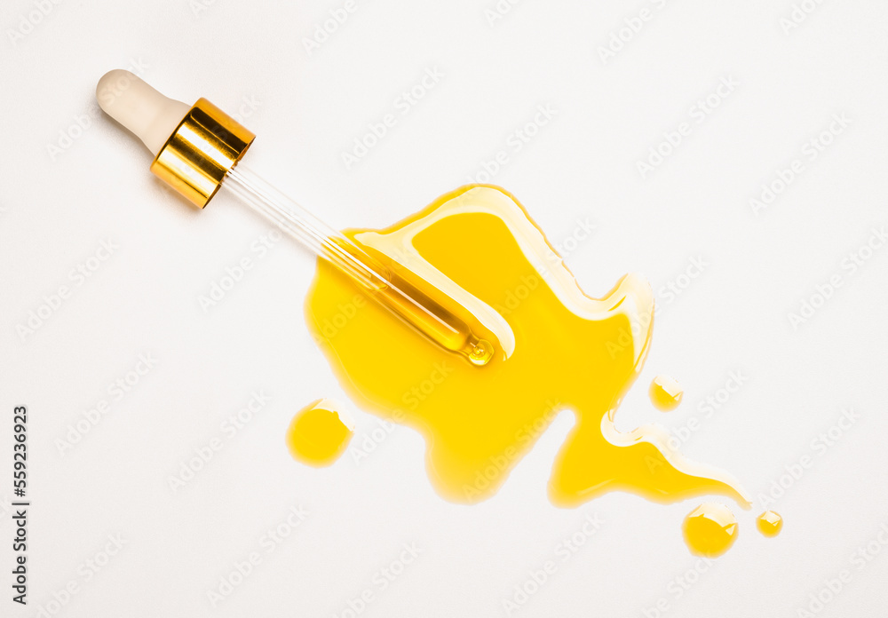 Cosmetic pipette with oil and drops, skin care oils natural organic cosmetic treatment, white background copy space.