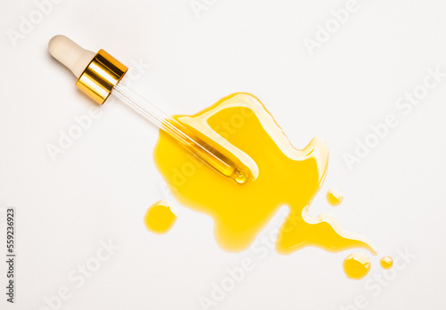 Obraz na płótnie Cosmetic pipette with oil and drops, skin care oils natural organic cosmetic treatment, white background copy space. w salonie