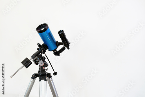 Astronomical telescope with Maksutov-Casegrain optical system (Catadioptric) on a tripod on a white background indoors