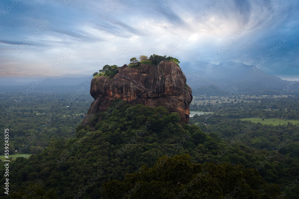 View from Pidurangala mountain to Sigiriya Lion Rock in Sri Lanka. Landscape panorama. After climb up the hill for tourists for wonderful view point to Lion Rock. View from Pidurangala mountain to Sigiriya Lion Rock in Sri Lanka. Landscape panorama. After climb up the hill for tourists for wonderful view point to Lion Rock.