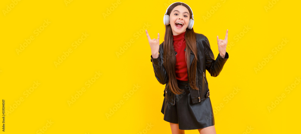 full length of cool child in headphones on yellow background. Child portrait with headphones, horizontal poster. Girl listening to music, banner with copy space. full length of cool child in headphones on yellow background. Child portrait with headphones, horizontal poster. Girl listening to music, banner with copy space.