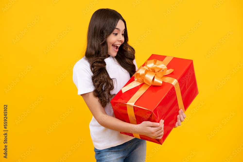 Amazed teenager. Child with gift present box on isolated background. Presents for birthday, Valentines day, New Year or Christmas. Excited teen girl. Amazed teenager. Child with gift present box on isolated background. Presents for birthday, Valentines day, New Year or Christmas. Excited teen girl.