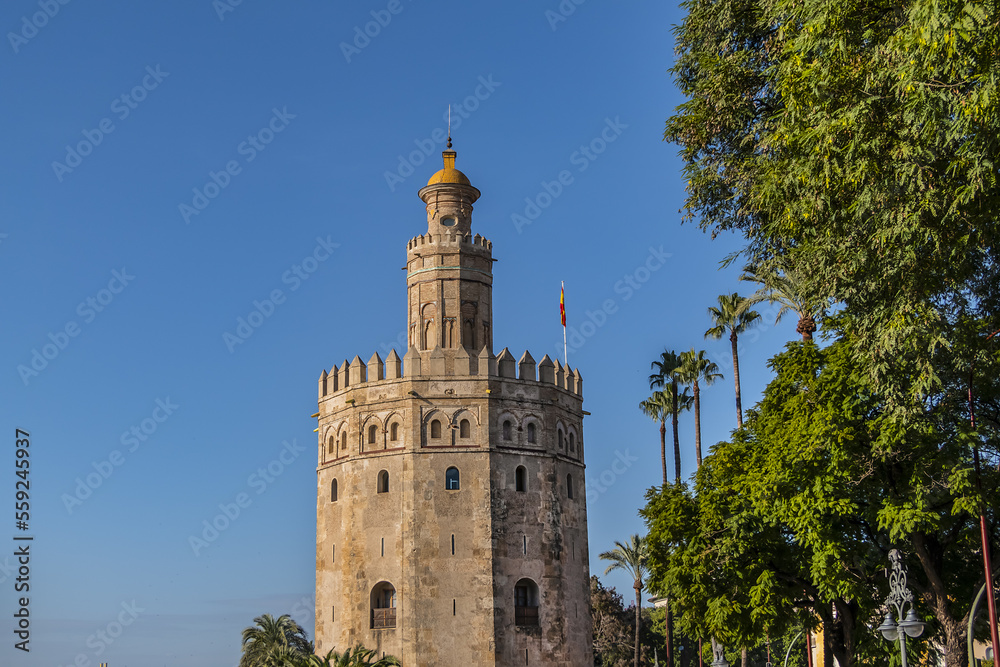 Golden Tower (Torre del Oro, from 13th century) located on the left bank of Guadalquivir River - historic military observation tower and Spanish cultural heritage monument. Seville, Andalusia, Spain. Golden Tower (Torre del Oro, from 13th century) located on the left bank of Guadalquivir River - historic military observation tower and Spanish cultural heritage monument. Seville, Andalusia, Spain.