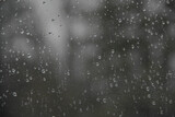 Closeup of rain drops on glass window pane, rainy day window background