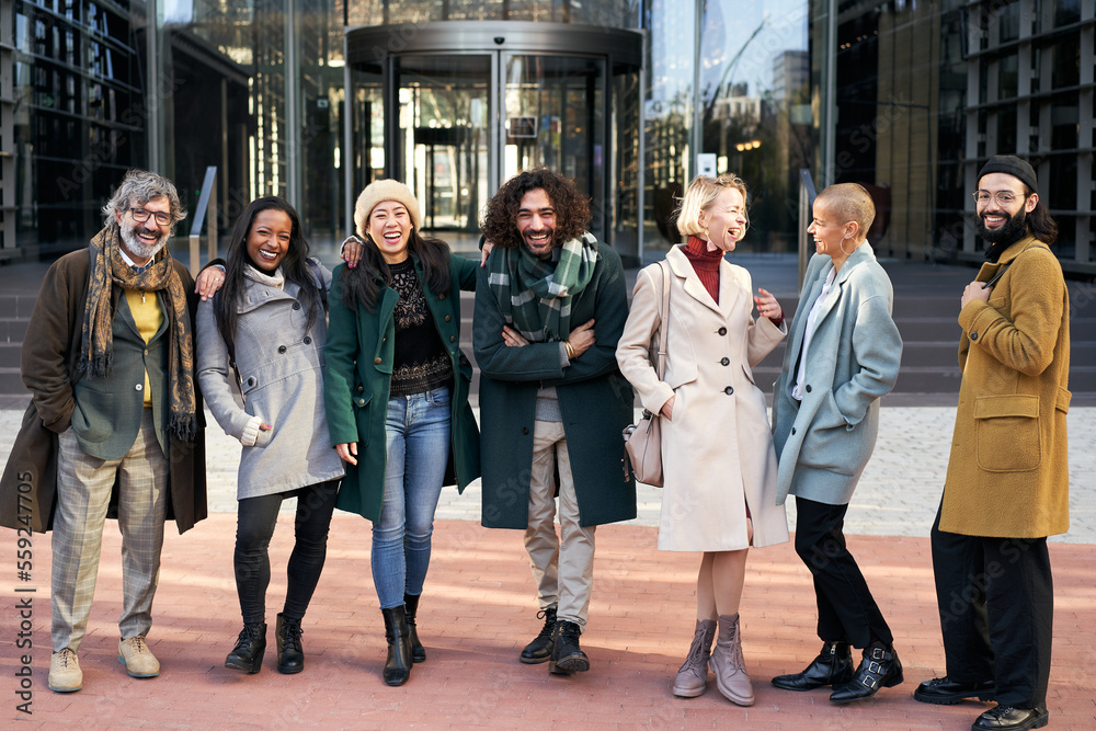Cheerful Portrait of a happy group of co-workers laughing and having fun outdoors a corporate office area. High quality photo Cheerful Portrait of a happy group of co-workers laughing and having fun outdoors a corporate office area. High quality photo