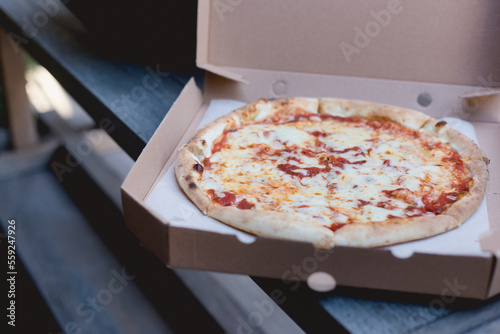 Close-up of margharita pizza in box on table photo