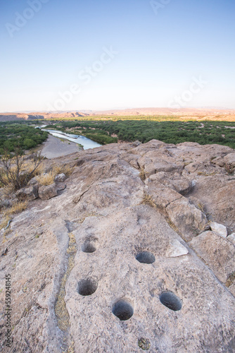 Six Grinding Holes In A Rock Outcrop Overlooking The Rio Grande River At The Border Of The Us And Mexico photo