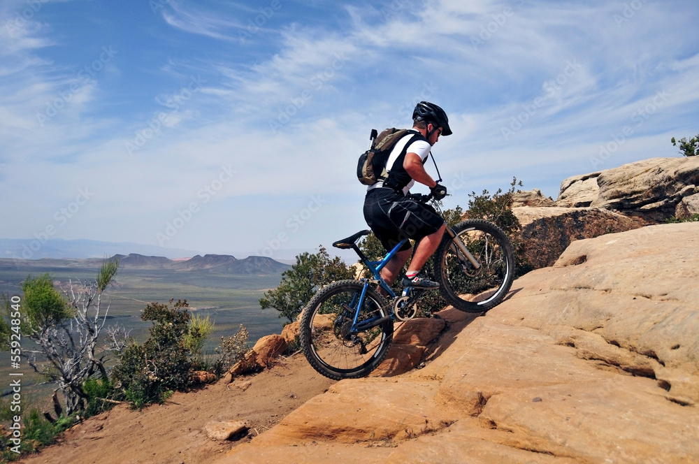 A man mountain bikes on the South Rim Trail of Gooseberry Mesa in southern Utah. A man mountain bikes on the South Rim Trail of Gooseberry Mesa in southern Utah.