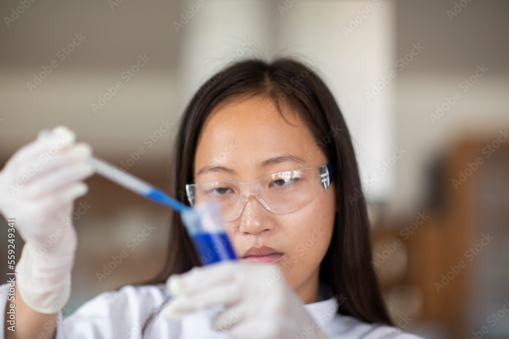 scientist female with lab glasses and tubes in a lab scientist female with lab glasses and tubes in a lab