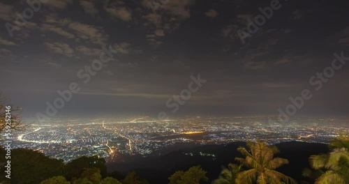 Panoramic view of the city of Chiang Mai from the mountain at dawn. Timelapse with a smooth transition from night to day