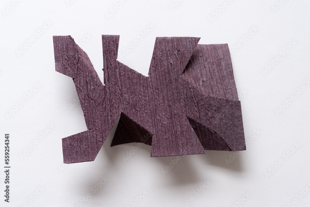 Obraz premium textured dark brown card with cut and folded edges on blank paper