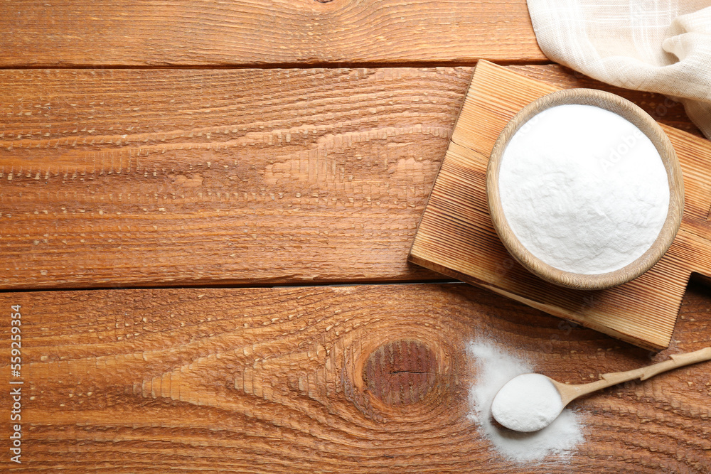 Baking soda on wooden table, flat lay. Space for text Baking soda on wooden table, flat lay. Space for text