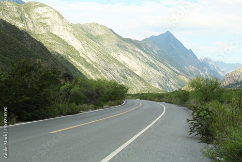 Beautiful view of empty asphalt highway near mountains outdoors. Road trip