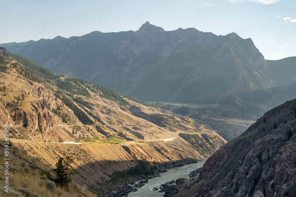 Obraz premium A Canadian highway through the British Columbia Caribou region on a sunny day. Near Lillooet BC, Canada.