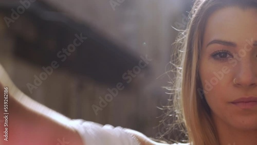 A beautiful young woman with a camera look, hides behind a scarf. Dordogne, Issigeac - France photo