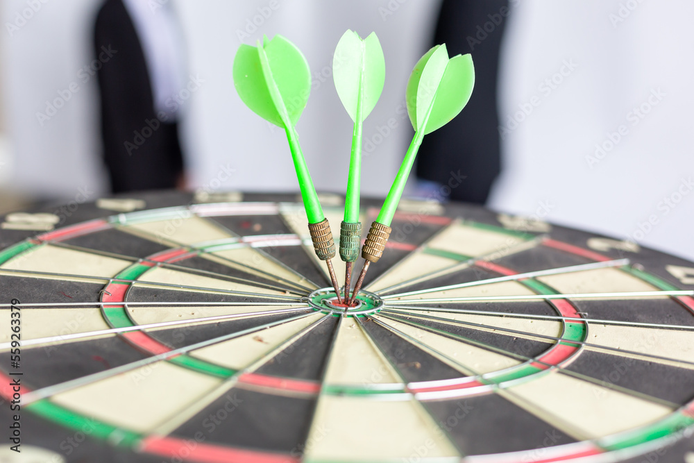 Dart arrow hitting in the target center of dartboard business targeting and winning goals business concepts, Darts hit target. It's like a successful business. Dart arrow hitting in the target center of dartboard business targeting and winning goals business concepts, Darts hit target. It's like a successful business.