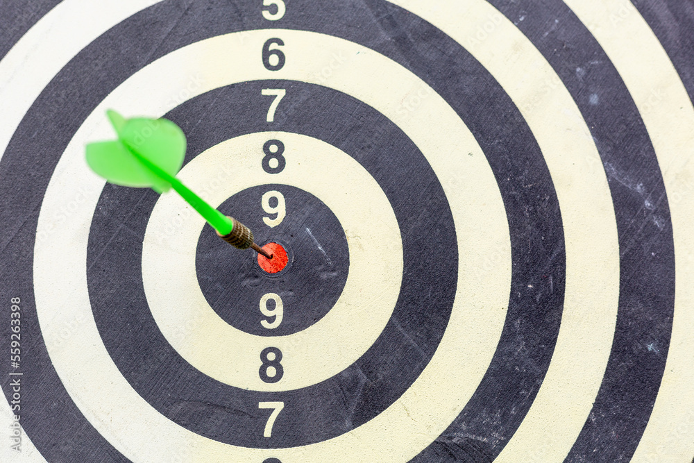 Dart arrow hitting in the target center of dartboard business targeting and winning goals business concepts, Darts hit target. It's like a successful business. Dart arrow hitting in the target center of dartboard business targeting and winning goals business concepts, Darts hit target. It's like a successful business.