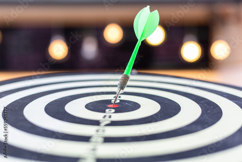Dart arrow hitting in the target center of dartboard business targeting and winning goals business concepts, Darts hit target. It's like a successful business.